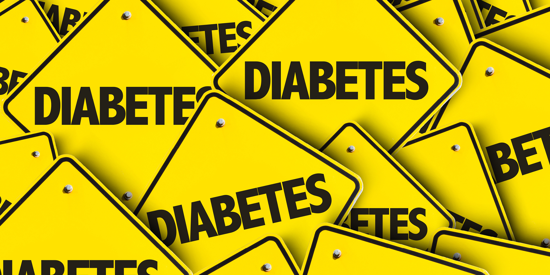 A pile of yellow Diabetes caution road signs