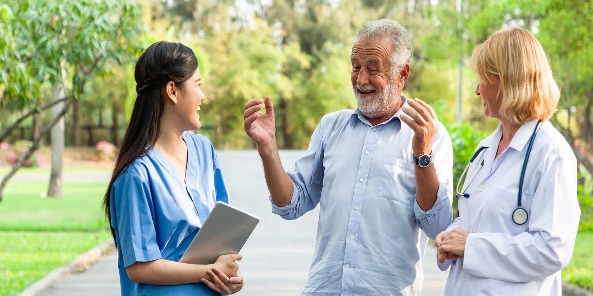Senior person interacting with two female medical staff | Doylestown Health