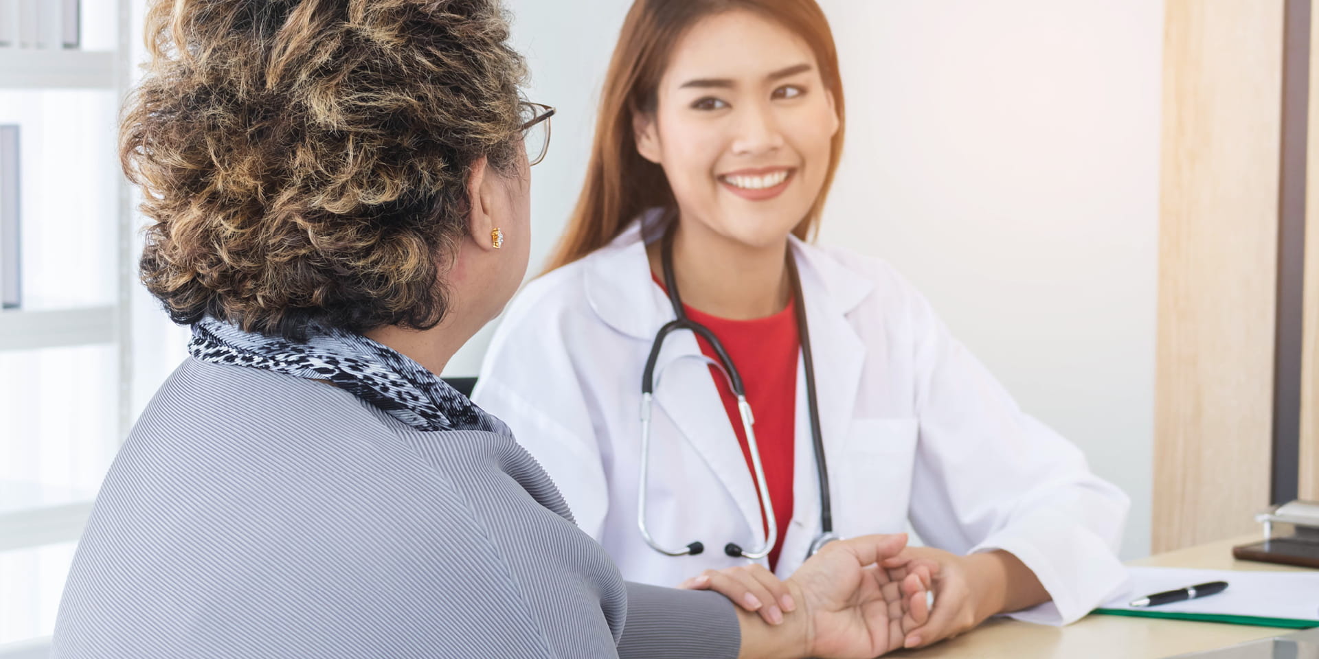 Health care provider smiling with older woman  | Doylestown Health