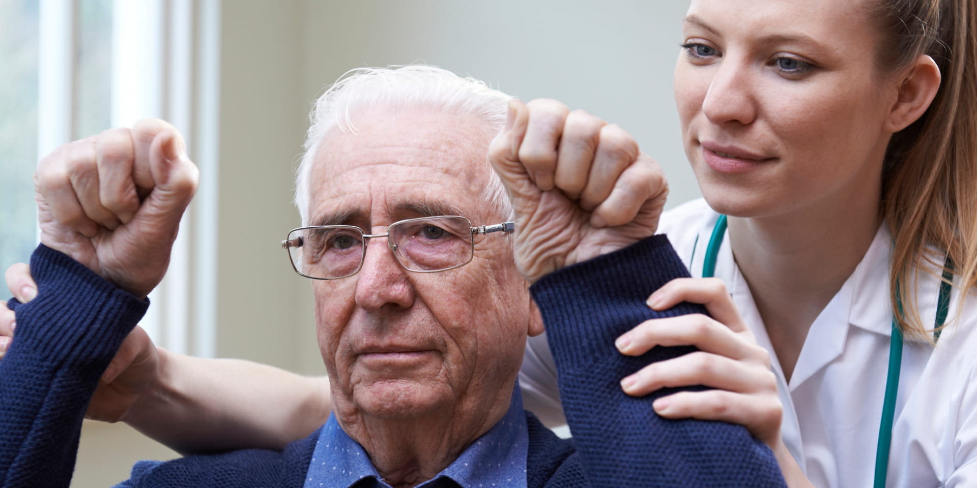 Older man who had a stroke working with a clinician.