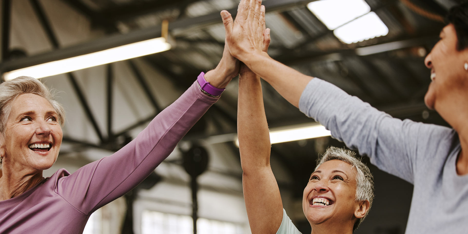 Three women doing a high five | Doylestown Health