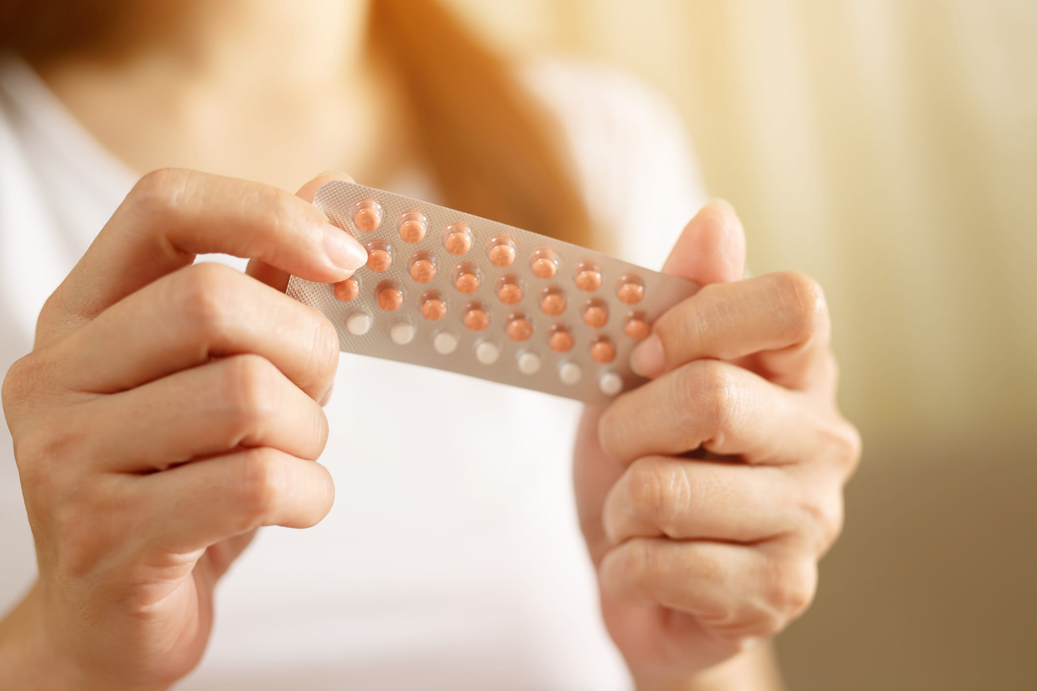 Woman holding birth control pills | Doylestown Health