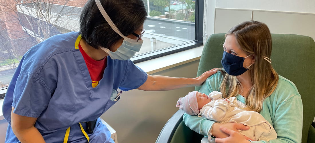 Woman with a baby speaking with a provider |  Doylestown Health