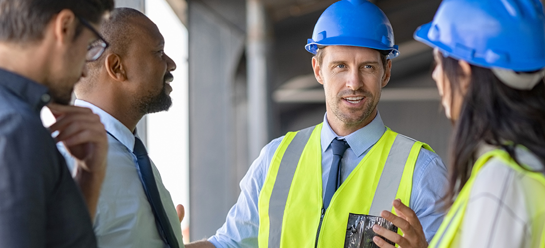 Engineers and architects in conversation at building site | Doylestown Health